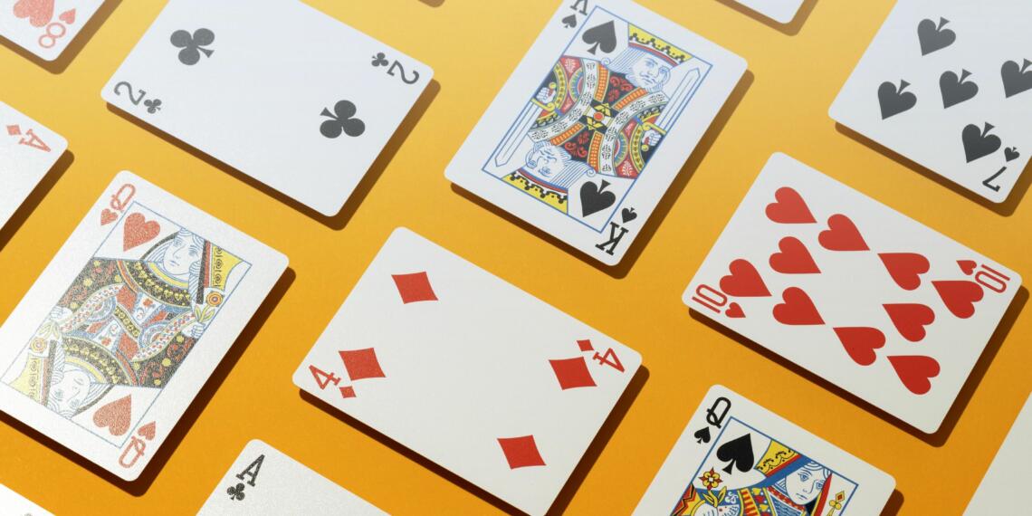 A close-up shot of a group of casino cards on a yellow background